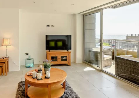 10 Waters Edge, Tenby is a two-bedroom luxurious seaside retreat, perfect for family holidays, offering stunning views, well-designed interiors, and easy access to local attractions, nestled on the Pembrokeshire Coast Path, close to the South Beach.