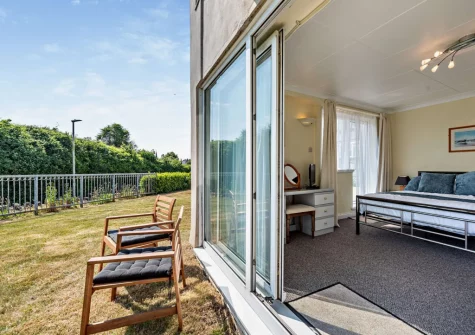 The atio doos from bedroom #1 open on to the shared garden at 112 Croft Court, Tenby