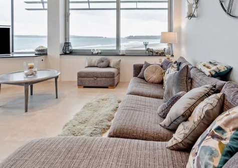 19 Waters Edge, Tenby is a stylish two-bedroom beachfront apartment directly on South Beach, featuring a private balcony terrace with fantastic sweeping sea views, contemporary interiors, and secure gated parking in vibrant coastal Tenby.
