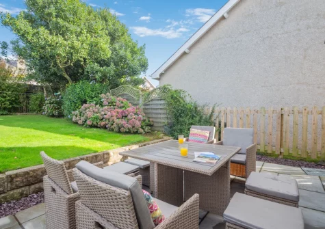 The patio, barbecue, alfresco dining area & enclosed rear garden at 3 Bro Terfyn, Morfa Nefyn