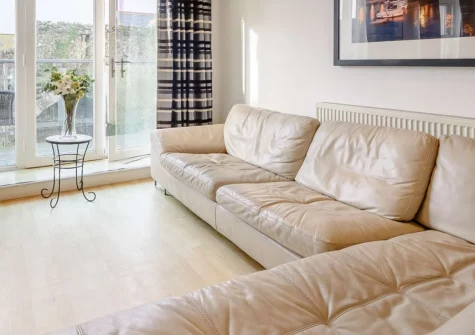 3 Cobourg House, Tenby is a spacious three-bedroom apartment within the medieval town walls, featuring a private balcony with views over ancient ramparts, contemporary open-plan living, and four golden beaches within easy walking distance.