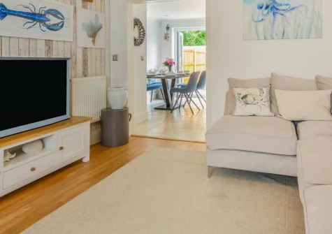 3 The Boatyard, Abersoch is a bright four-bedroom house just 200 metres from Abersoch Harbour Beach, featuring a sunny balcony and sheltered patio, stylish modern interiors, and the golden sandsn of the Llŷn Peninsula on your doorstep.