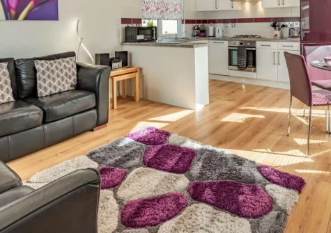 92 Heritage Park, Stepaside is a charming two-bedroom woodland lodge set within a peaceful holiday park in rural Pembrokeshire, featuring stylish contemporary interiors, a private decked area, and easy access to golden beaches and coastal paths.