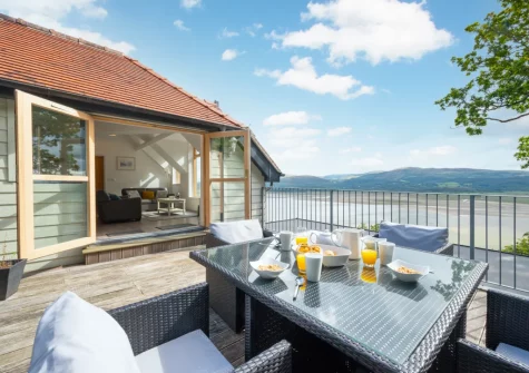 The decked patio, barbecue & alfresco dining area at Apartment 4, The Old Stables, Aberdovey
