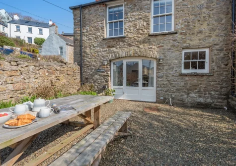 The enclosed courtyard garden & alfresco dining area at Berry Cottage, Little Haven
