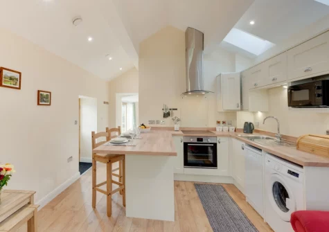 The kitchen & breakfast bar dining area at Beudy Bach, Llanrwst