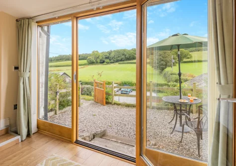 The bedroom opens on to the enclosed patio & alfresco dining area at Beudy Bach, Llanrwst