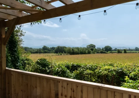 The countryside view from the decked patio & outdoor sitting area at Blochdy, Brynsiencyn