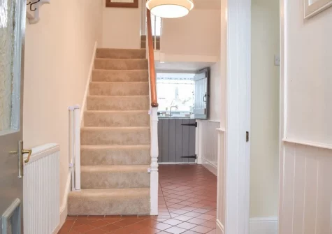 The hallway & stairs up to the first floor at Bluebell House, Tenby