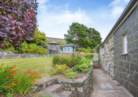 The beautifully manicured lawned garden at Bron Y Gadair, Llanfair