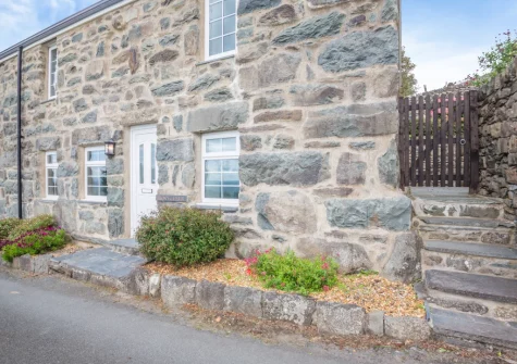 Bron Y Gadair is a detached stone house in Llanfair with games room, summer house, enclosed garden & sea views