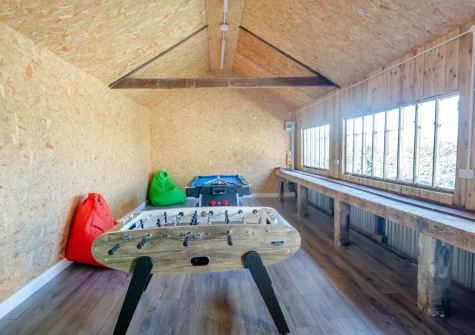 The games room with pool table, dartboard & table football