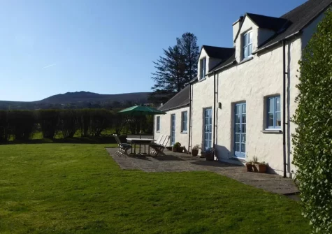 The patio, alfresco dining area & large lawned wraparound garden at Brynceirios, Newport