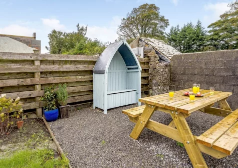The alfresco dining area & enclosed garden at Bryncoed, Narberth