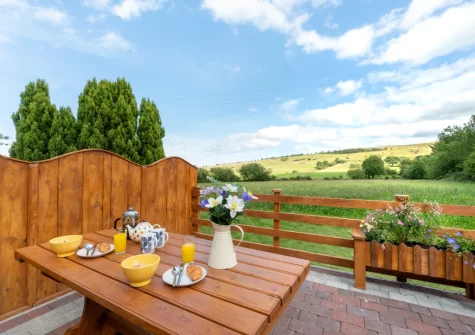 The enclosed patio & alfresco dining area at Bryniau Pair Ucha Cottage, Pandy Tudur