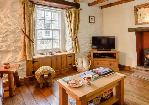 Bwthyn Clyd, St Davids, is a charming Grade 2 listed stone cottage in the heart of Britain's smallest city. With original beams, a cosy wood burner, and proximity to the coast, it's perfect for families seeking authentic Welsh coastal charm.