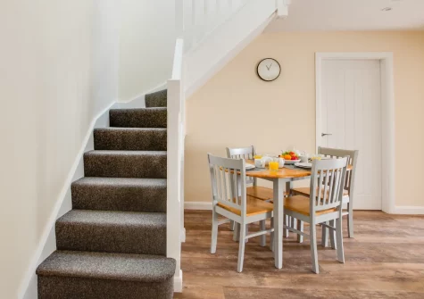 The dining area & stairs up to the first floor at Bwthyn Clyd, Talwrn