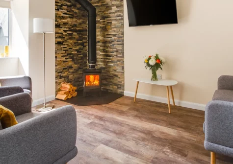 Bwthyn Clyd, Talwrn is a beautifully renovated stone cottage on a working Anglesey farm, featuring a roll-top bath, cosy log fire, and a tranquil courtyard with sweeping views towards the mountains of Snowdonia, just moments from Anglesey's beaches.
