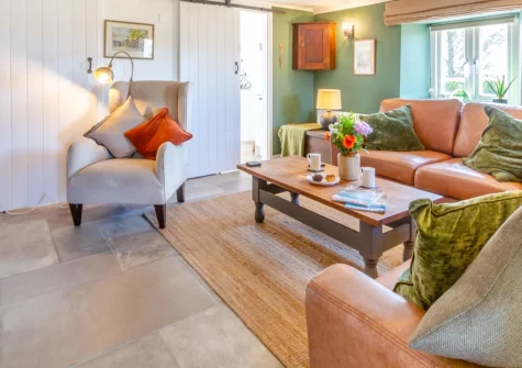 Bwthyn Craig Wen, Mynytho is a beautifully restored cottage in a peaceful village on the Llŷn Peninsula, featuring a first-floor balcony with panoramic views towards St Tudwal's Islands, characterful interiors with wood burner, and beaches nearby.