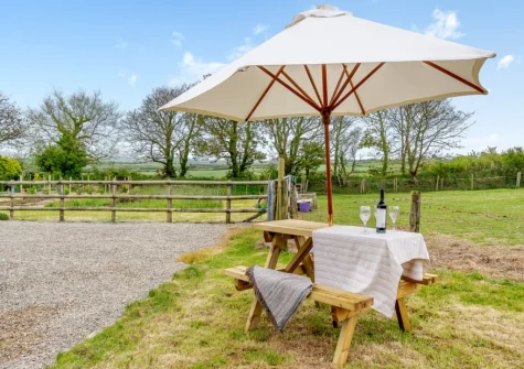 The alfresco dining area & garden at Caerau Bach, Trefin