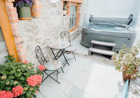 The patio, outdoor sitting area & hot tub at China Cottage, Tenby