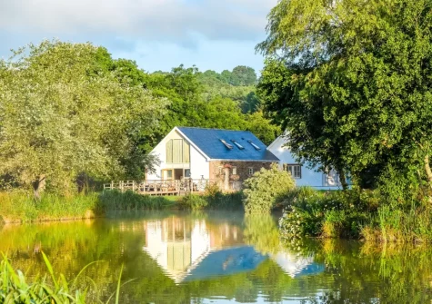 The View towards the cottages from across the fishing lakes at Clear View, Llawhaden