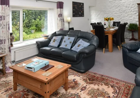 Cleggars Castle, Templeton is a welcoming three-bedroom cottage perfect for families, featuring a private decked area ideal for delightful al fresco dining, children's play facilities, and beautiful peaceful Pembrokeshire holiday grounds.