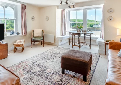 Cliff Cottage, Alfardisworthy is a characterful four-bedroom clifftop retreat overlooking Little Haven village and the sea beyond, featuring a wood burner, secluded garden with multiple terraces, and spectacular sunsets above Pembrokeshire's coast.