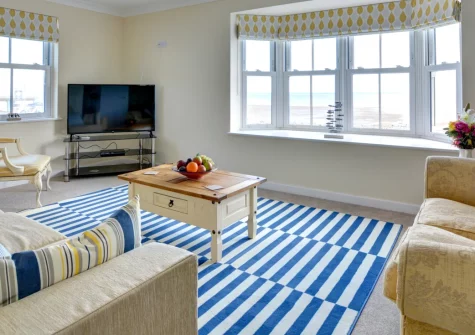 Cockleshell, Amroth is a bright three-storey house directly opposite the beach, offering sea views from the first-floor living spaces, five flexible bedrooms, a sunny patio, and effortless access to Pembrokeshire's stunning coastline and attractions.