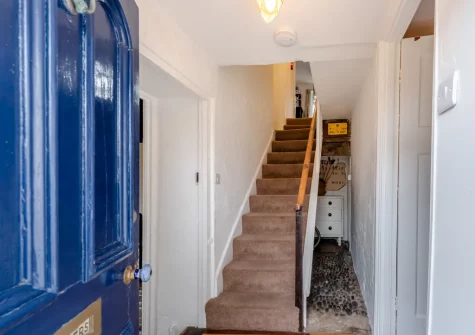 The entrance hallway & stairs up to the first floor at Curlew Cottage, Manorbier