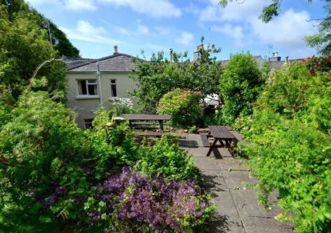 The patio, alfresco dining area & rear garden at Curlew Cottage, Manorbier