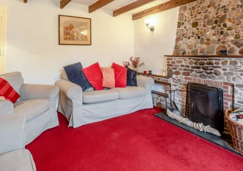 Curlew Cottage, Manorbier is a spacious Georgian house in this historic coastal village, featuring four bedrooms, extensive gardens with raised terrace and coastal views, and a cosy beamed sitting room with log burner, close to castle and beach.
