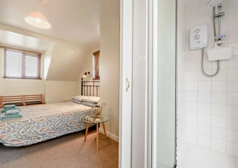 Bedroom #1 & en-suite shower room at Curlew House, Broad Haven