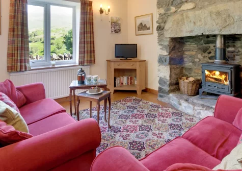 Cwm Glas Bach, Nant Peris is a rustic stone cottage sitting beneath Snowdon's slopes, featuring a wood burner, exposed beams, a garden stream and mountain views, perfect for ramblers seeking a base for exploring Eryri and the national park.