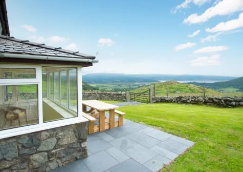The patio, alfresco dining area & lawned garden at Cwm Mawr, Cwmystradllyn