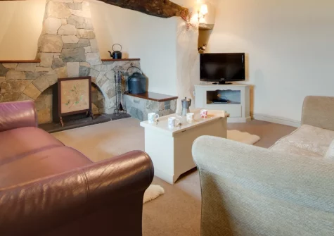Cwm Mawr, Cwmystradllyn is a characterful 400-year-old farmhouse sleeping six, set on a working hill farm with panoramic Cardigan Bay views. Enjoy inglenook fires, a cosy garden and easy access to Snowdonia's castles, beaches and attractions.