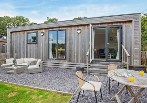 The gravelled patio, alfresco dining & outdoor sitting area at Dragonfly Lodge, Tyn-y-Groes