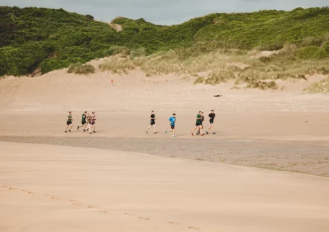 Freshwater East Beach is a wide, south-facing bay of golden sand nestled within the Pembrokeshire Coast National Park featuring sheltered, clear blue waters popular with families, swimmers & water sports enthusiasts