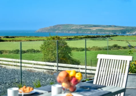 The coast & sea view from the patio & alfresco dining area at Geufron House, Aberdaron