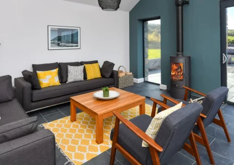 Geufron House, Aberdaron is a stylish four-bedroom house with spectacular, unspoilt sea views over Aberdaron Bay, featuring a cosy snug, wood burner, large patio with BBQ, and private parking, just minutes from the beach and village shops.