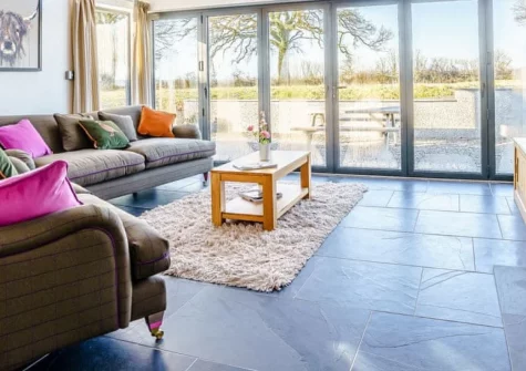 Glowty Newydd, Llandissilio is a four-bedroom barn conversion sleeping eight in rural Pembrokeshire, featuring open-plan living with woodburner and bi-fold doors, a generous garden with barbecue facilities, and easy access to coastal treasures.