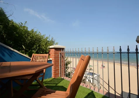 The terrace at Goscar View looks over the sandy beach below