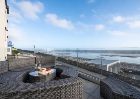 The glass-fronted balcony & outdoor sitting area at Graig Y Don, Amroth
