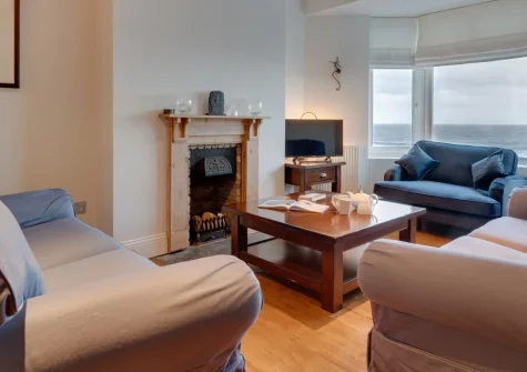 Graig Y Don, Amroth is a spacious four-bedroom house directly opposite the beach, featuring a stunning glass-fronted balcony with sea views, open-plan living spaces, and the village's shops, pubs, and Pembrokeshire Coast Path just steps away.