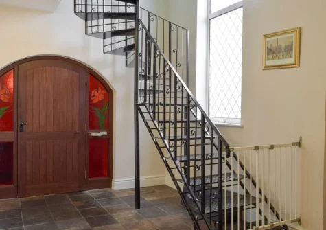 The ornate wrought iron stairs up to the first floor at Green Acre Cottage, Kilgetty