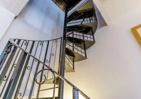 The spiral staircase up to the bedroom at Green Cottage Coach House, Tenby