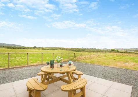 The patio, barbecue, alfresco dining area & lawned garden at Gwel Y Mynydd, Penrhos Feilw