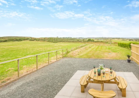The patio, barbecue, alfresco dining area & lawned garden at Gwel Y Mynydd, Penrhos Feilw