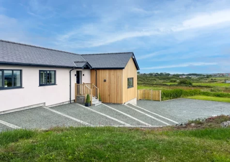 Gwel Y Mynydd is a contemporary coastal holiday home with garden, parking and superb views over Anglesey Island
