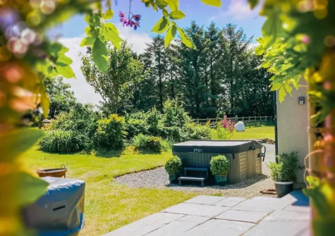 The spacious patio, hot tub & garden at Hafan Fach Cottage, Maidenwells